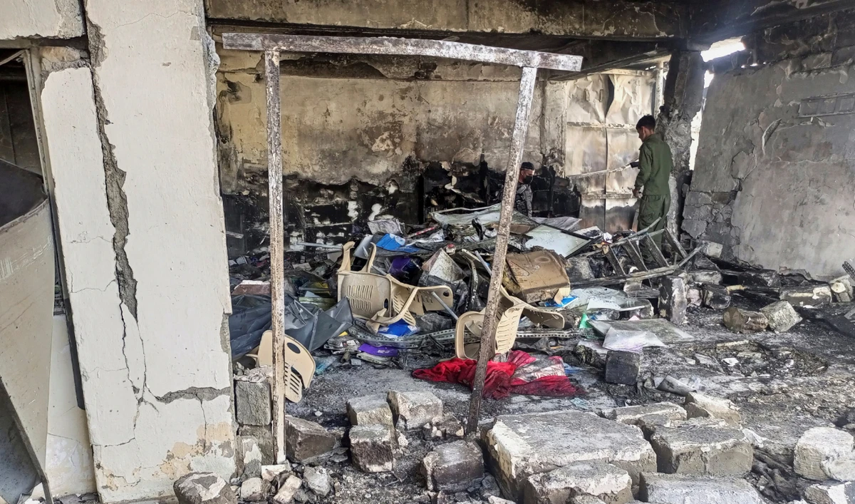 Security forces inspect through the debris of a damaged building in the aftermath of air strikes in Sinjar district, Iraq, June 15, 2022. (Reuters)