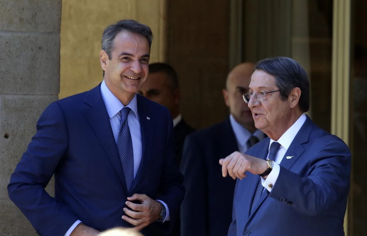 Cypriot President Nicos Anastasiades and Greek Prime Minister Kyriakos Mitsotakis talk before their meeting at the Presidential Palace in Nicosia on Friday. (AP)