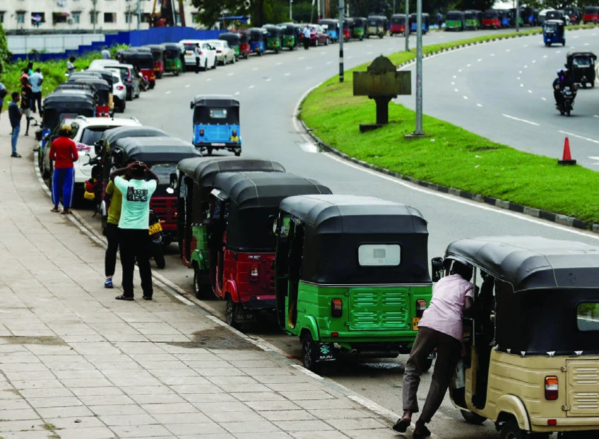 Three-wheeler drivers wait in a queue to buy petrol due to fuel shortage, amid the country’s economic crisis, in Colombo, on Friday. (Reuters)