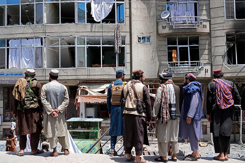 Taliban fighters gather at the site of an explosion in front of a Sikh temple in Kabul, Afghanistan, Saturday, June 18, 2022. (AP)