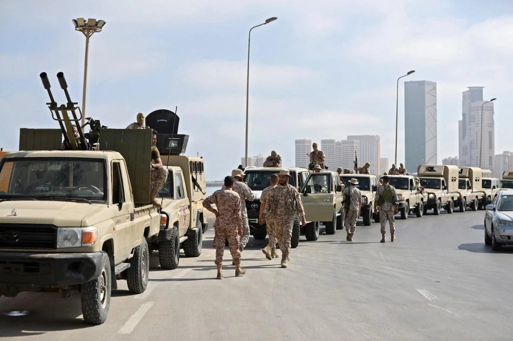 Above, forces loyal to Libya’s Tripoli-based Prime Minister Abdulhamid Dbeibah are parked along the waterfront on May 17, 2022. (AFP)