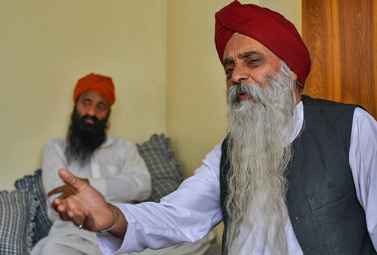 An Afghan Sikh, Manmohan Singh Sethi (R), speaks to AFP inside a room during an interview in Kabul on June 20, 2022. (AFP)
