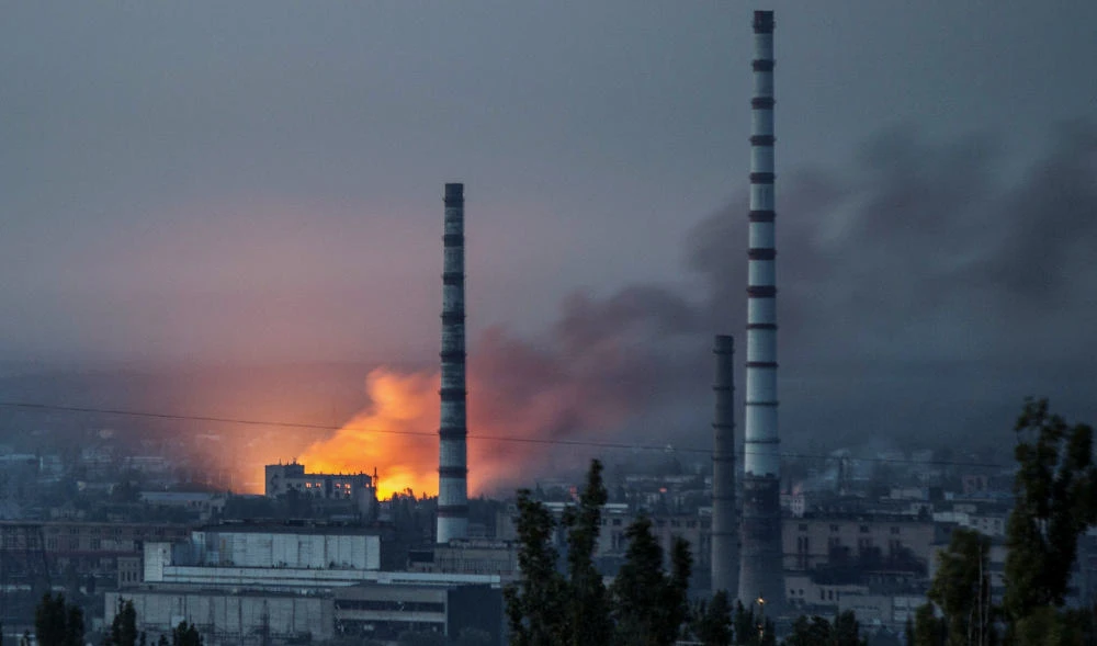 Smoke and flame rise after a military strike on a compound of Sievierodonetsk's Azot Chemical Plant, as Russia's attack on Ukraine continues, in Lysychansk, Luhansk region, Ukraine June 18, 2022. (REUTERS)