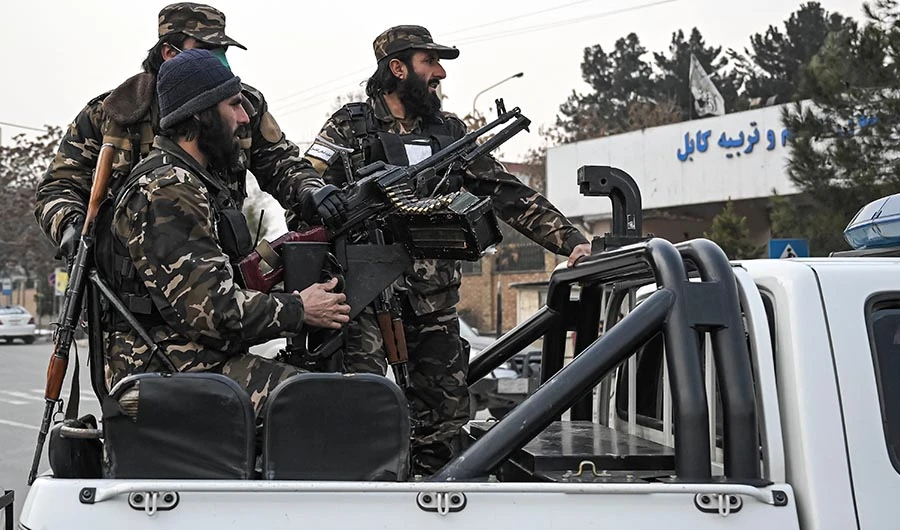 Taliban fighters patrol along a street during a demonstration by people to condemn the recent protest by the Afghan women's rights activists, in Kabul on January 21, 2022. (AFP)