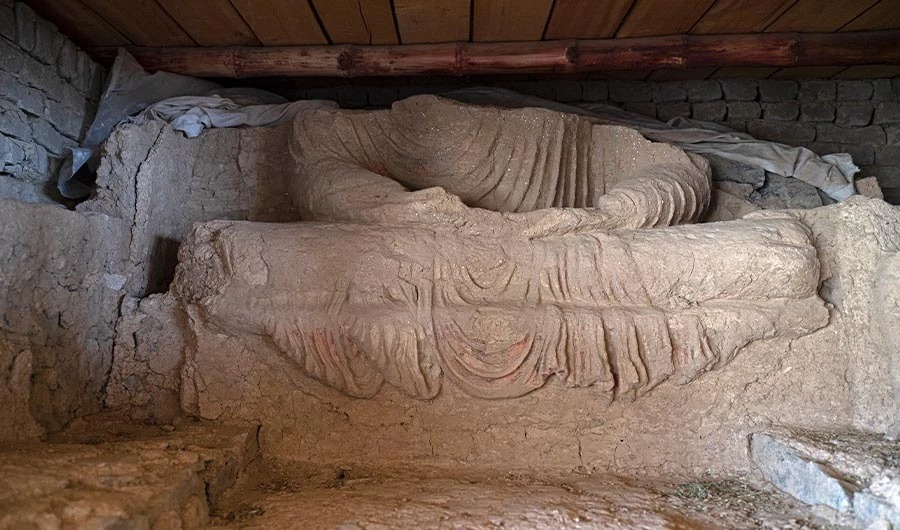 This picture taken on May 17, 2022, shows a part of a statue of Buddha after being uncovered at an archaeological site in Mes Aynak, in the eastern province of Logar. (AFP)