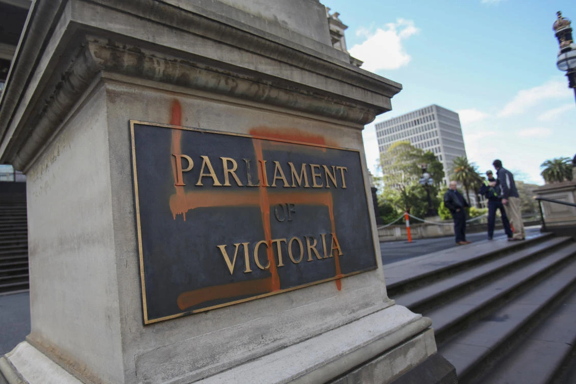The Parliament of Victoria passed laws that set penalties of $15,213 and 12 months in prison for displaying the Nazi swastika. A Nazi swastika graffitied on the front of the Victorian State Parliament. (AAP Image via AP)