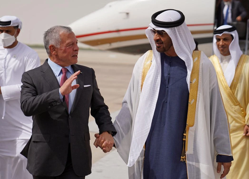 Sheikh Mohamed bin Zayed al-Nahyan (C-R), President of the UAE, receives Jordan's King Abdullah II (L) upon his arrival at the Presidential Airport in Abu Dhabi on June 23, 2022. (AFP)