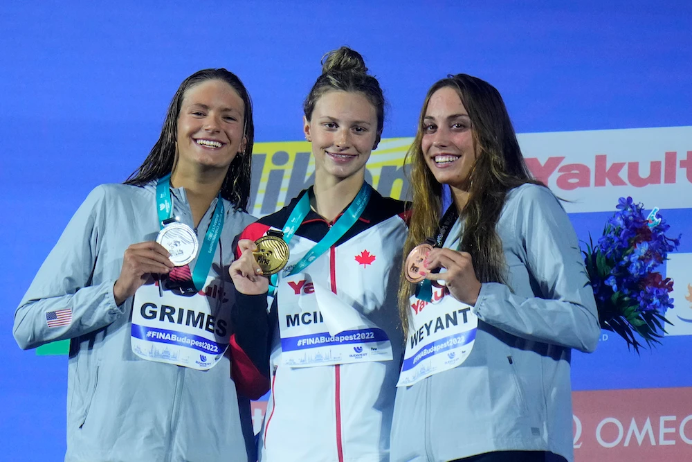Summer McIntosh, center, of Canada, second-place Katie Grimes left, of the US, and third-place Emma Weyant, of the US, at the podium after the women’s 50m freestyle final at the 19th FINA World Championships. (AP)