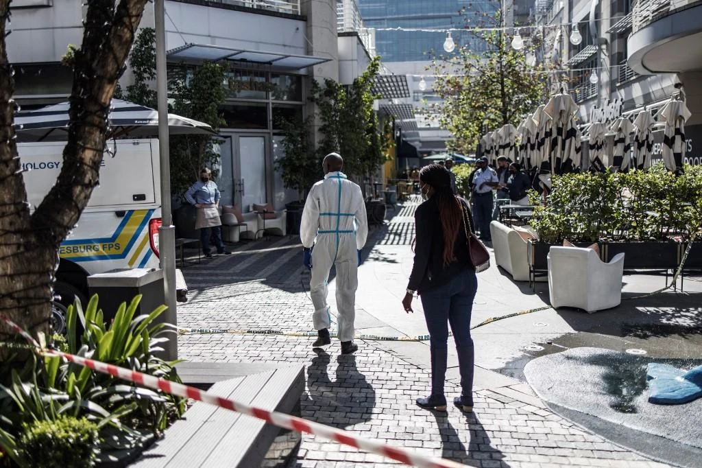 A South African forensic pathologist works at the site of a fatal shooting. (File/AFP)