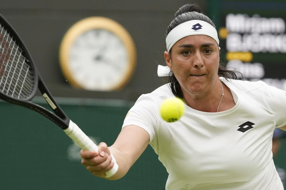 Tunisia’s Ons Jabeur returns the ball to Sweden’s Mirjam Bjorklund during their women’s singles tennis match on day one of the Wimbledon tennis championships in London, Monday, June 27, 2022. (AP)