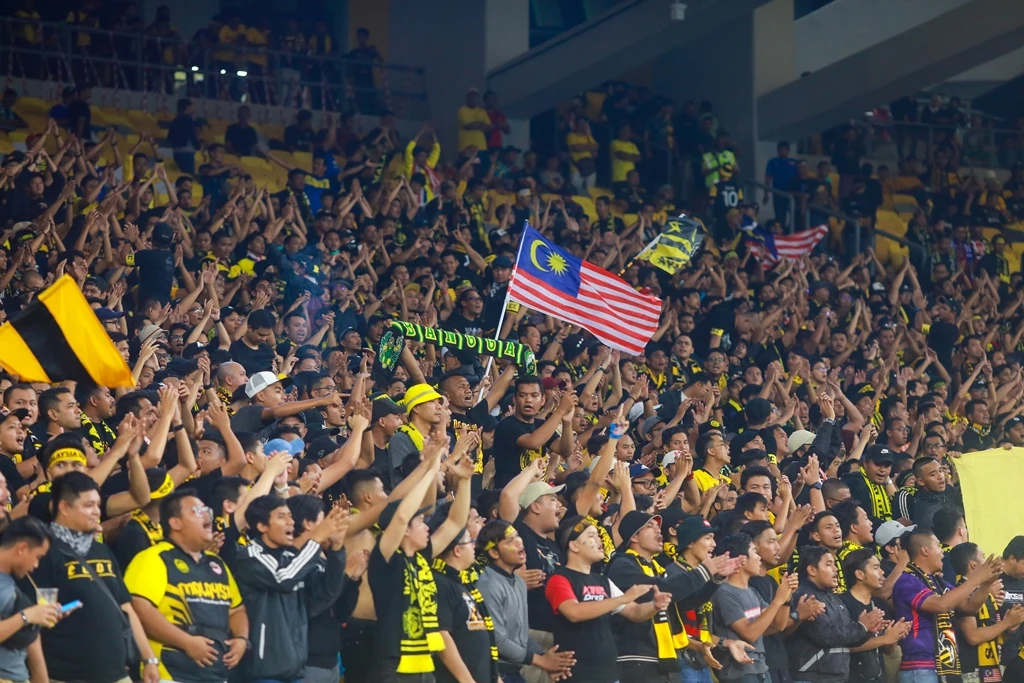 Unidentified Malaysia fans during the FIFA World Cup Qatar 2022 and AFC Asian Cup China 2023 Qualification matches between Malaysia and UAE at Bukit Jalil Stadium. (Shutterstock)