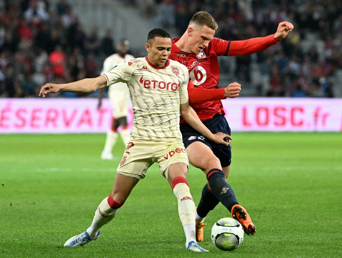 Sven Botman (right) and Monaco's Brazilian defender Vanderson (left) fight for the ball during the French L1 football match between Lille OSC and AS Monaco in northern France. (AFP)