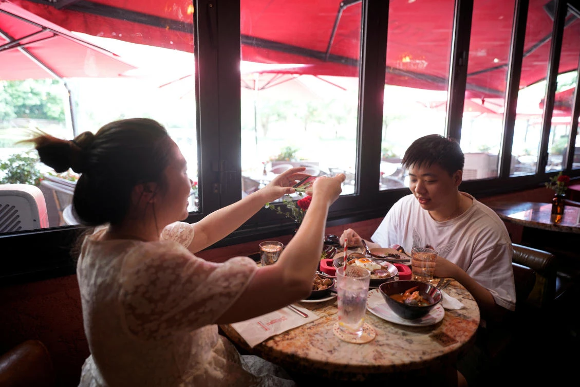 Some restaurant owners said they had not yet received the green light from their districts and are required to cap customer numbers at 50 percent as well as a limit each session to 90 minutes. (Reuters)