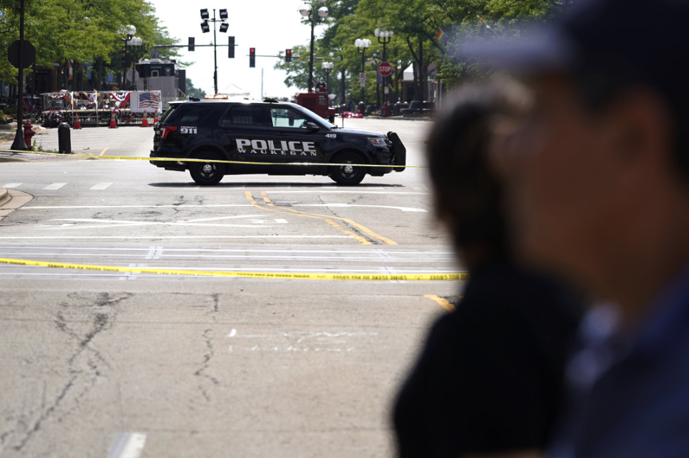 A police vehicle blocks the road on Central avenue where multiple people were killed in Monday’s Fourth of July mass shooting.