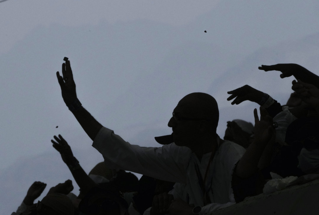 Muslim pilgrims cast stones in the symbolic stoning of the devil ritual during the Hajj pilgrimage, in Mina. (AP)