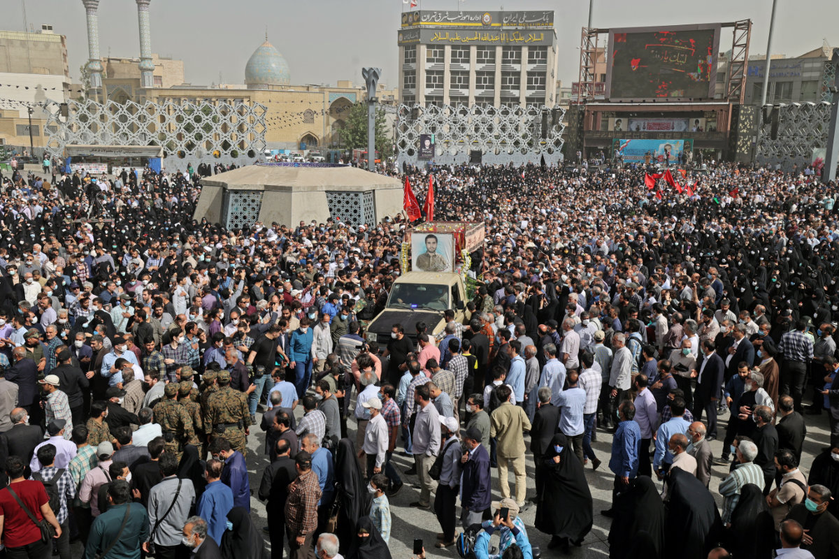 Iranians gather in Tehran on May 24, 2022, to bury the body of IRGC colonel Sayyad Khodai. (AFP)