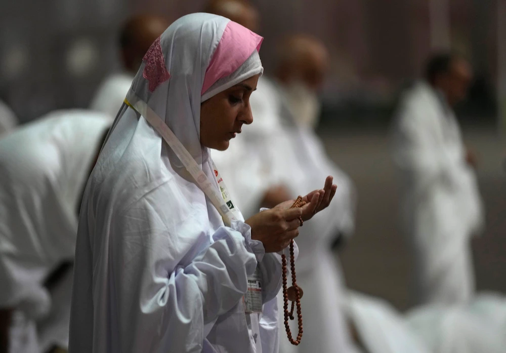 A pilgrim pray on the rocky hill of Mount Arafat. (AP)