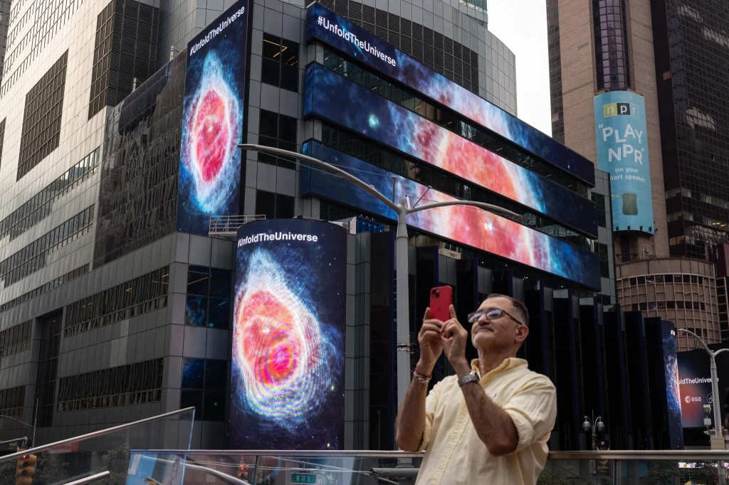 Above, images captured by The James Webb Space Telescope are displayed on screens at Times Square in New York. (AFP)