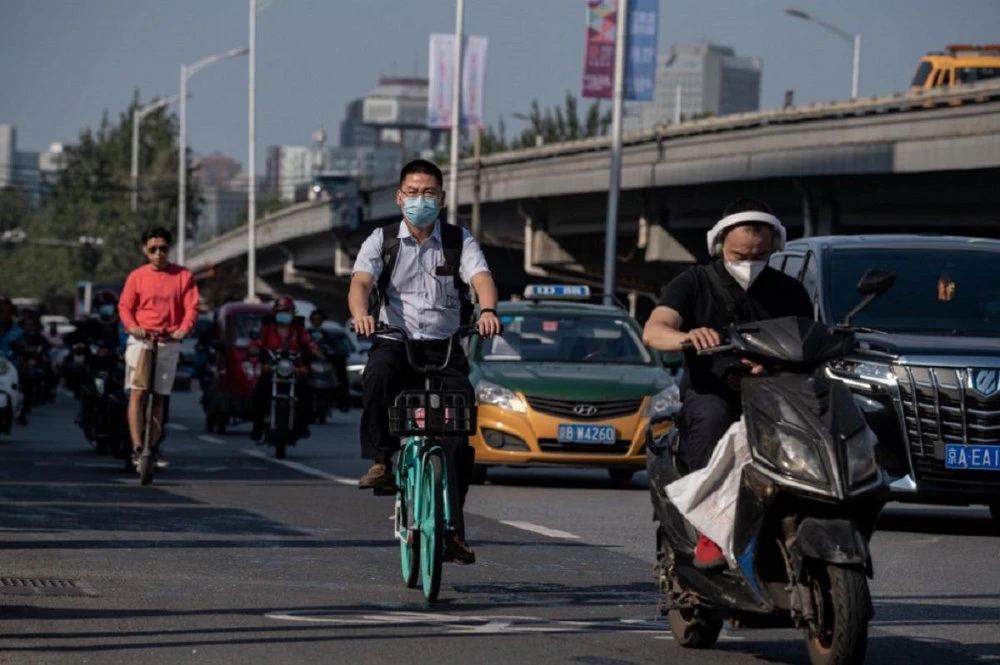 People commute in Beijing, China. (AFP)