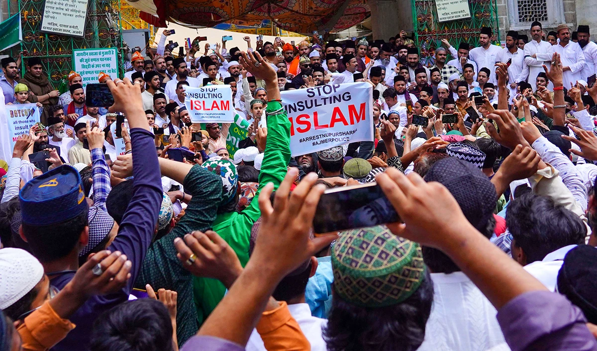 Muslims hold placards during a silent demonstration to protest against India's Bharatiya Janata Party former spokeswoman Nupur Sharma over her incendiary remarks about Prophet Muhammad (PBUH), in Ajmer on June 17, 2022. (AFP/File)