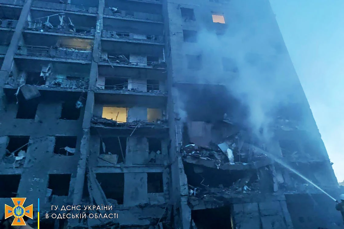 This handout picture released by the Ukraine’s State Emergency Service on Friday shows a firefighter putting out the fire in a residents building hit by a missile strike in Odessa, killing over 16 and 30 injuring. (AFP)