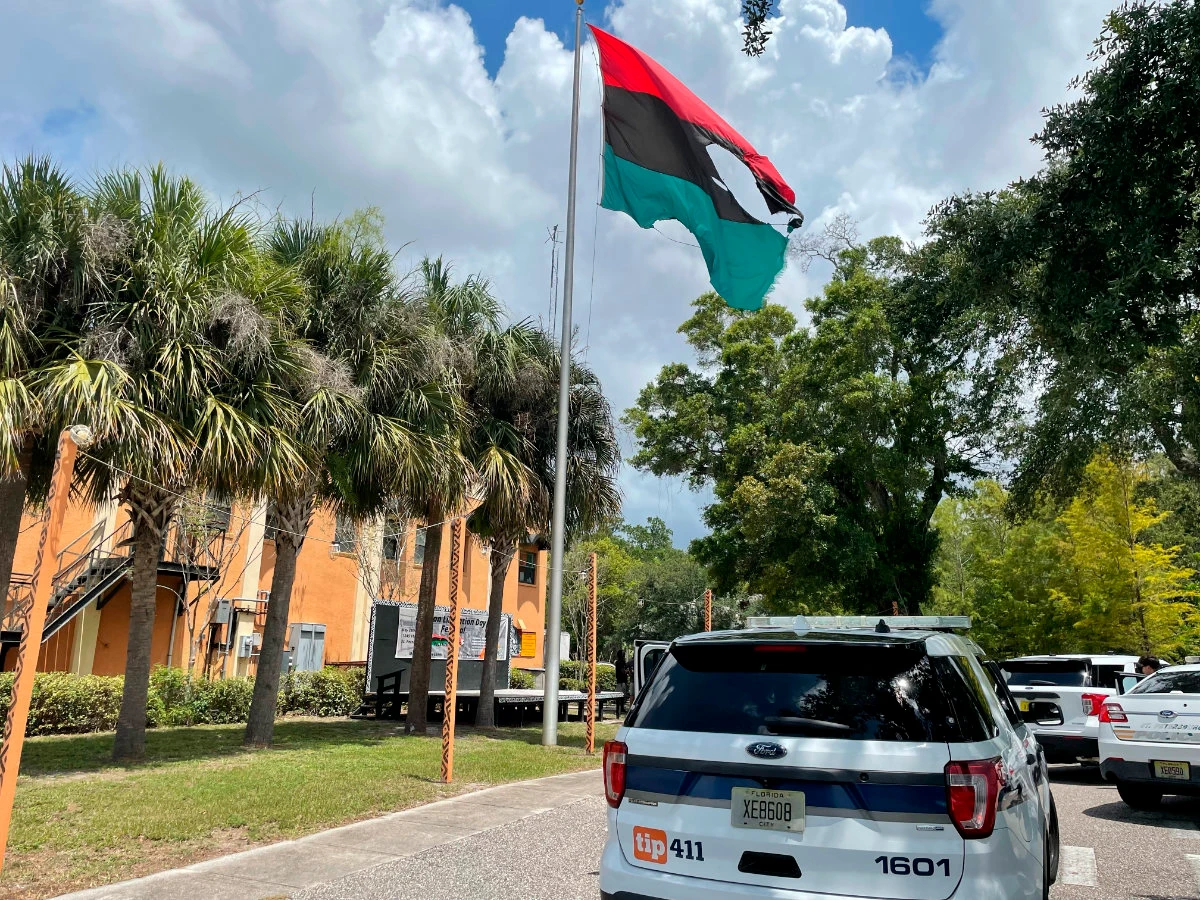 A big hole is seen on a Pan-African flag mounted on a pole outside the headquarters of a Black international socialist group in Florida after it was hit with a flame thrower. (AP)