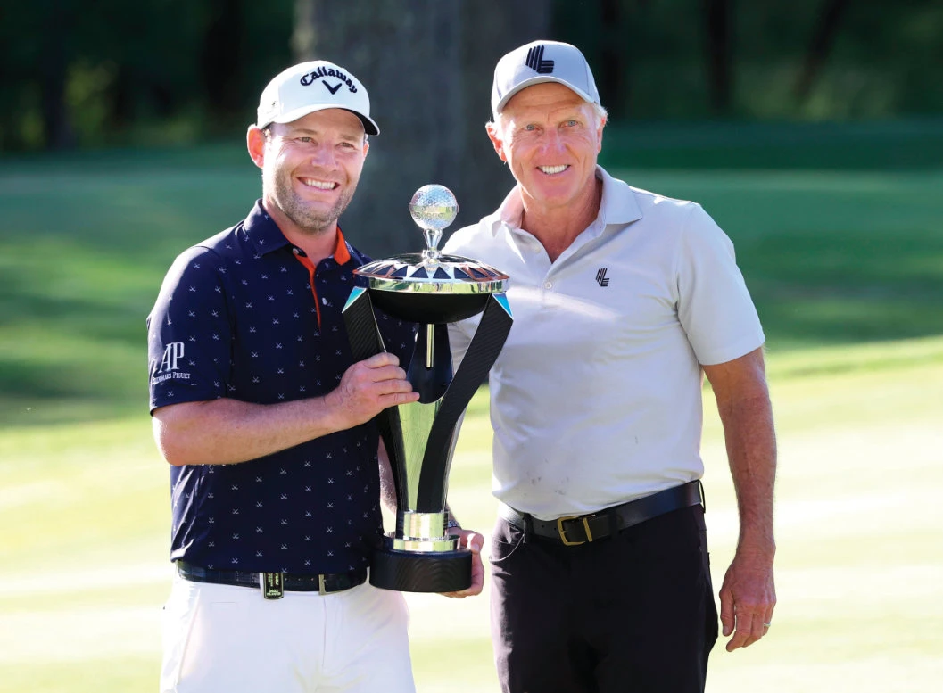 Branden Grace, left, and LIV Golf CEO Greg Norman pose with the trophy after Grace won the Portland Invitational LIV Golf tournament in North Plains, Ore., on Saturday. (AP)