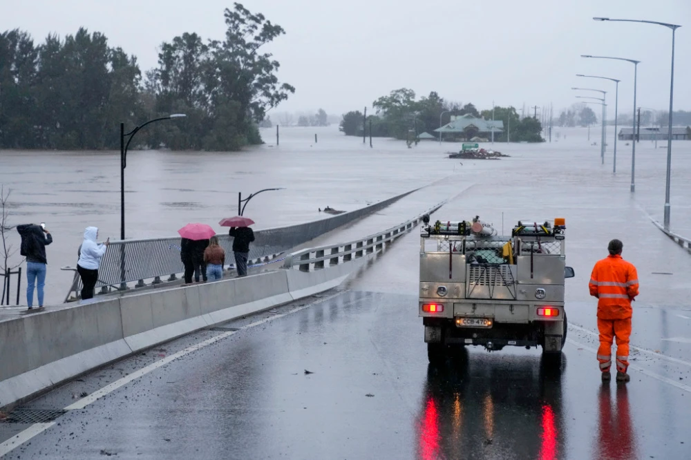 An emergency vehicle blocks access to the flooded Windsor Bridge on the outskirts of Sydney, Australia, Monday, July 4, 2022. (AP)