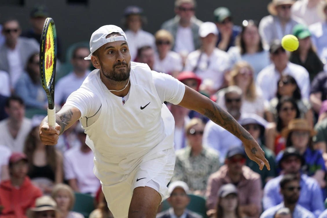 Australia’s Nick Kyrgios returns to Brandon Nakashima of the US in a men’s singles fourth round match on day eight of the Wimbledon tennis championships in London, on Monday. (AP)