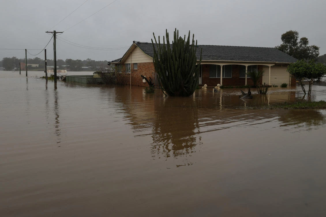 Across Sydney’s western fringe, rivers broke their banks and large areas have been transformed into inland lakes, with mud-brown waters invading homes while cutting off roads and bridges. (Reuters)