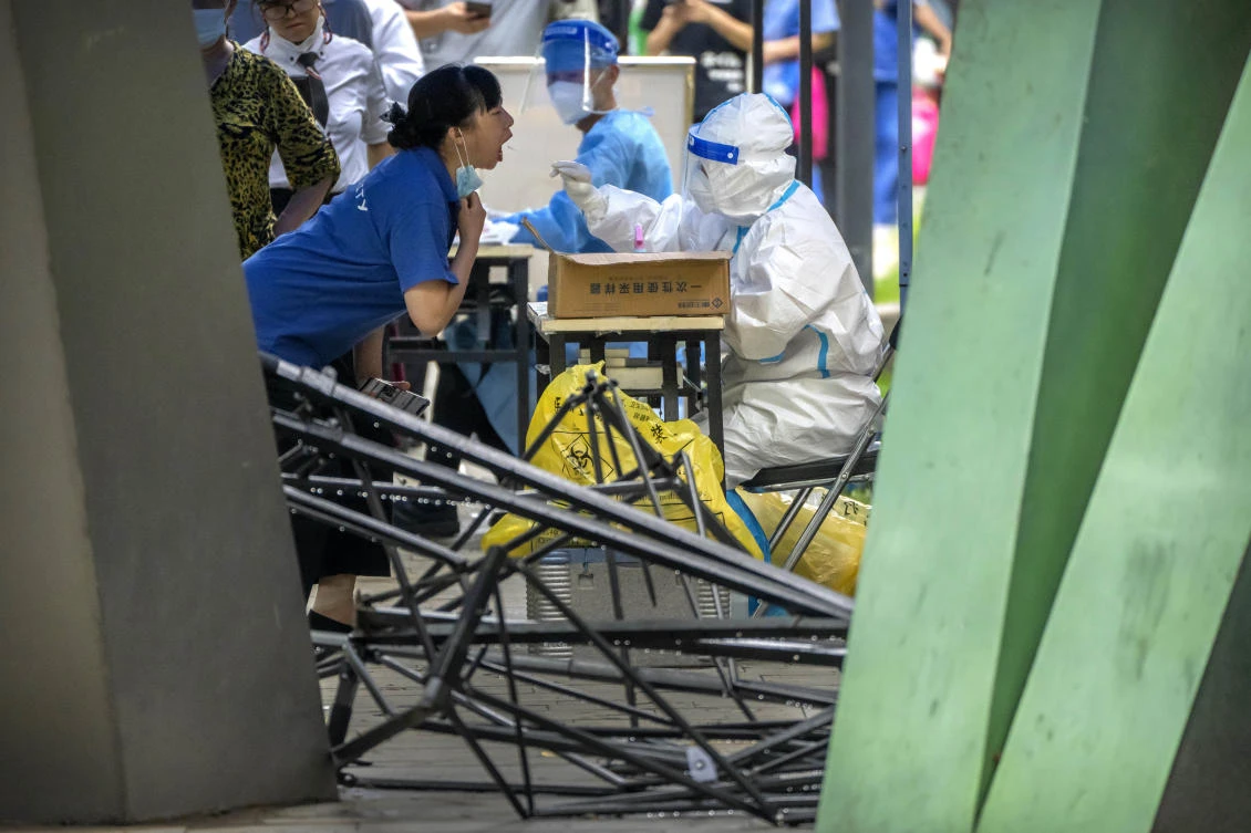 Beijing has seen a recent COVID-19 outbreak linked to a nightlife spot. Above, a resident gets swabbed at a coronavirus testing site in the city. (AP)