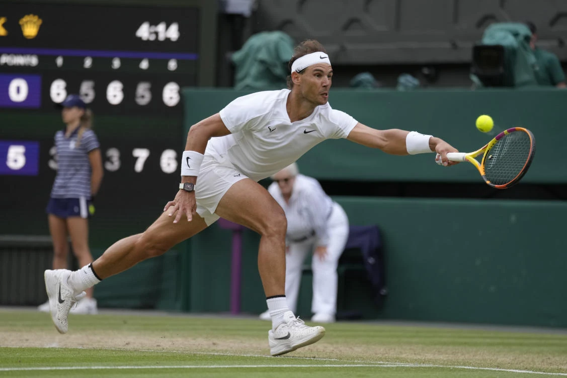 Spain’s Rafael Nadal returns to Taylor Fritz of the US in a men’s singles quarterfinal match on day ten of the Wimbledon tennis championships in London, Wednesday. (AP)