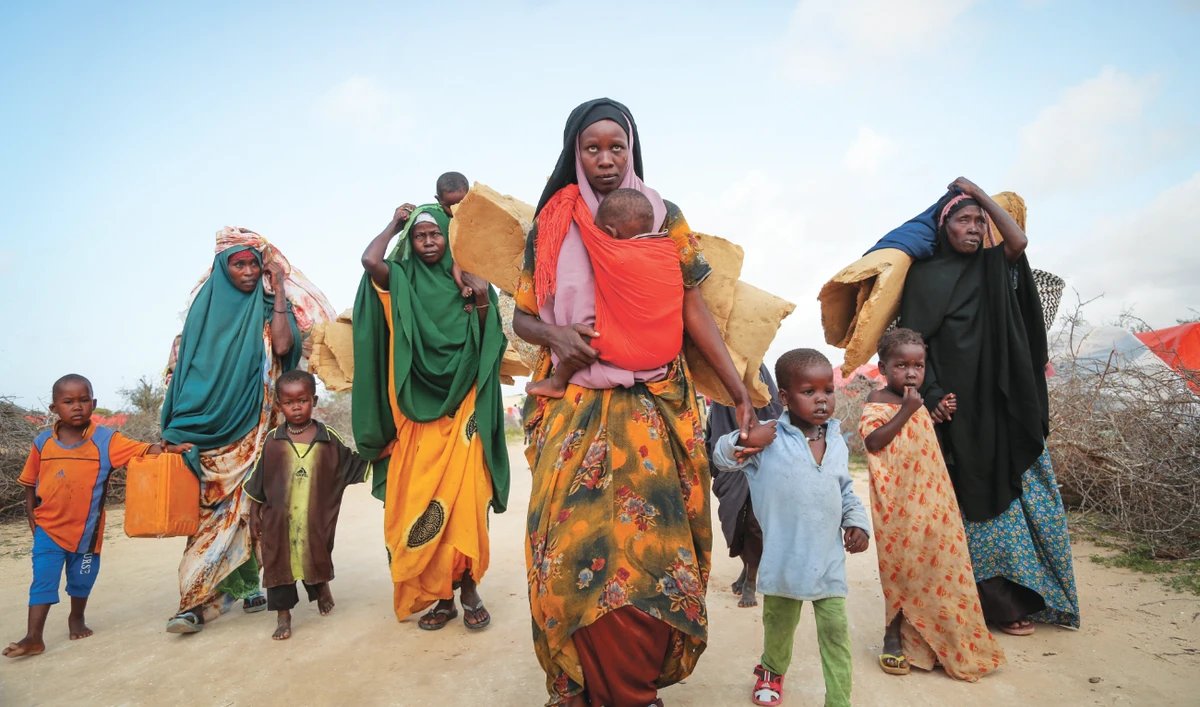 Somalis who fled drought-stricken areas carry their belongings as they arrive at a makeshift camp for the displaced on the outskirts of Mogadishu. (AP)