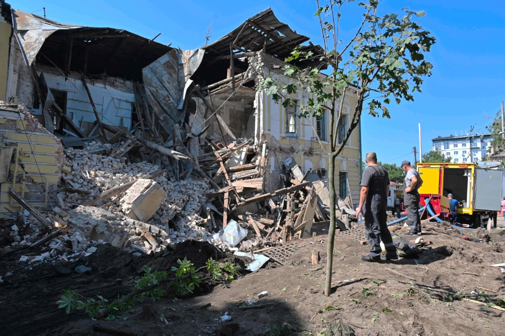 Resсuers work among ruins of a building destroyed by Russian missiles in Kharkiv on July 6, 2022. Thalita do Valle was killed while serving Kharkiv on June 30. (AFP)