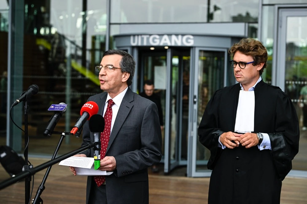 Spokesman of the NCRI Foreign Affairs Committee and lawyer Rik Vanreusel, right, stand in front of the Court of Appeal of Antwerp, which delivers judgement. (AFP/File)