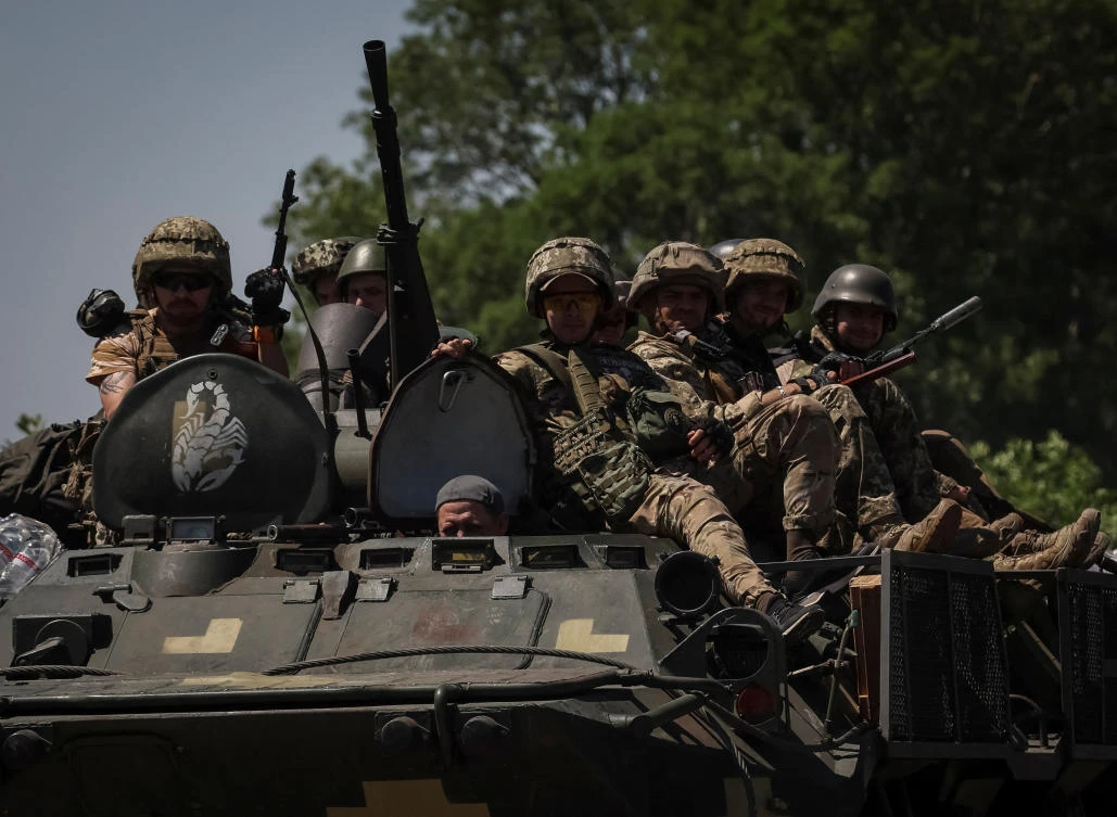Ukrainian service members ride an armored personnel carrier in Donetsk region on July 7, 2022. (Reuters)