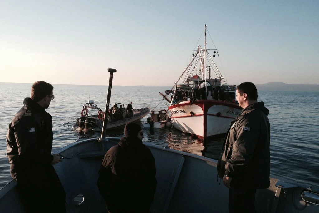 Greek coast guards tow a small boat used by migrants trying to reach Europe, off the island of Lesvos, on March 18, 2014. (Hellenic Coast Guard/AFP)