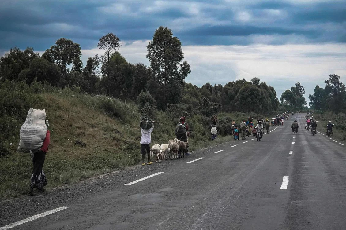 Residents leave Kibati and Kibumba village in the Democratic Republic of Congo following clashes between government troops and rebel forces on May 24, 2022. (AFP)