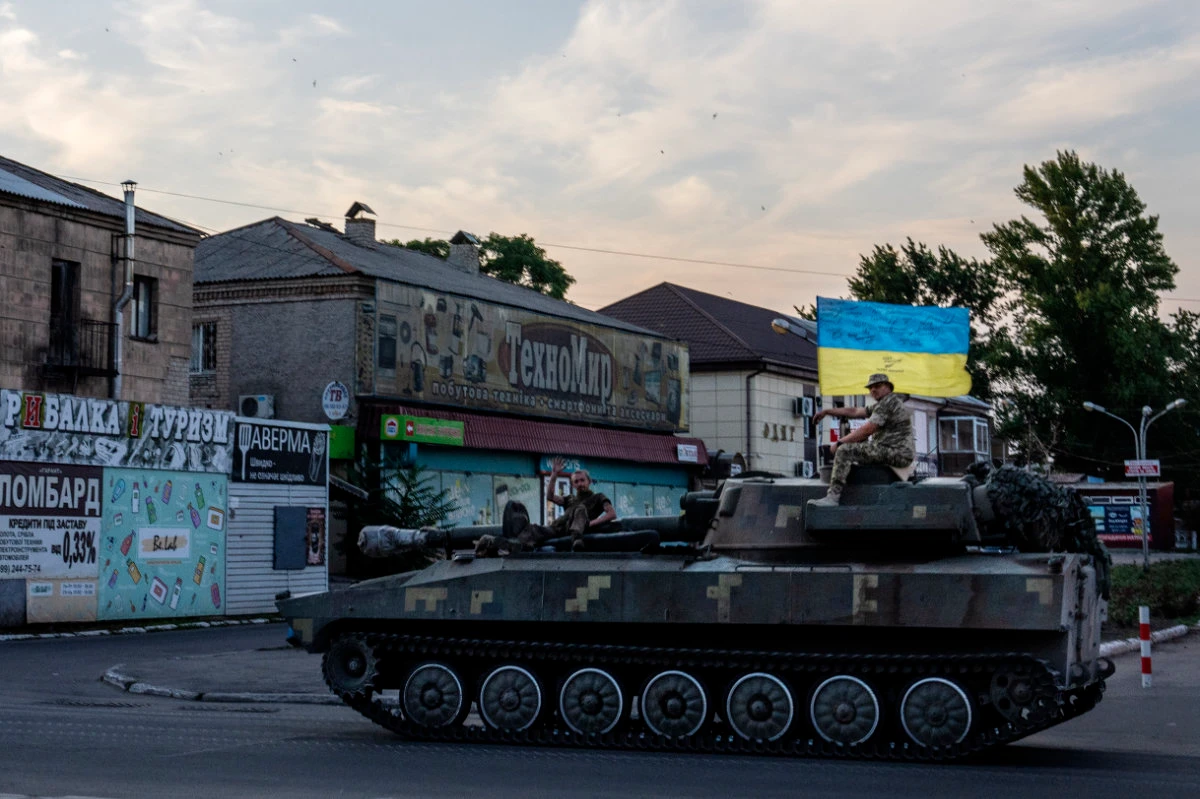 Ukrainian soldiers ride atop a tank through a street in Pokrovsk, Donetsk region, in eastern Ukraine on July 8, 2022. (AP)