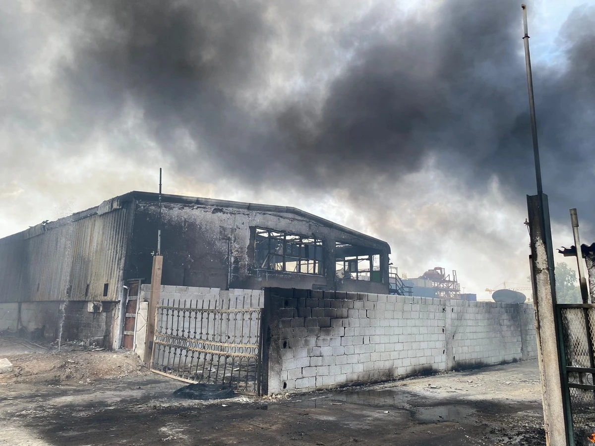 Cause of the fire that broke out in an Abu Dhabi warehouse remains under investigation. (Photo by Abu Dhabi Police Twitter)