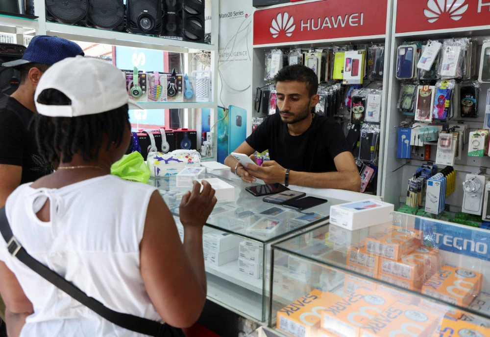 A vendor assists customers inside a mobile shop in Dora, Lebanon July 9, 2022. (REUTERS)