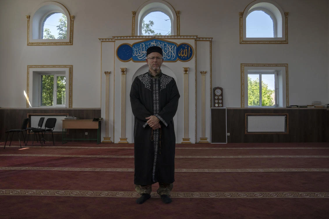 Former Mufti-turned-fighter Sheikh Said Ismahilov, stands for a portrait, after leading Muslim soldiers during prayers on the first day of Eid al-Adha, in Medina Mosque, Konstantinovka, eastern Ukraine, Saturday, July 9, 2022. (AP)