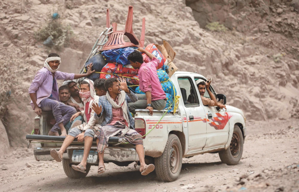 An overloaded vehicle drives through a damaged narrow road in the mountains near Taiz. The road serves as a lifeline between Taiz and Aden. (AFP)