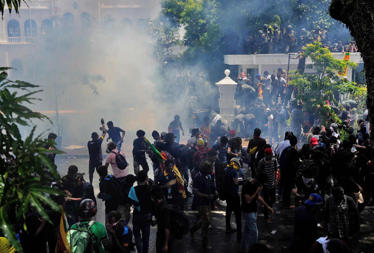 Police use teargas as Sri Lankan protesters storm the compound of prime minister Ranil Wickremesinghe 's office, demanding he resign after president Gotabaya Rajapaksa fled amid economic crisis in Colombo, Sri Lanka, on July 13, 2022. (AP)