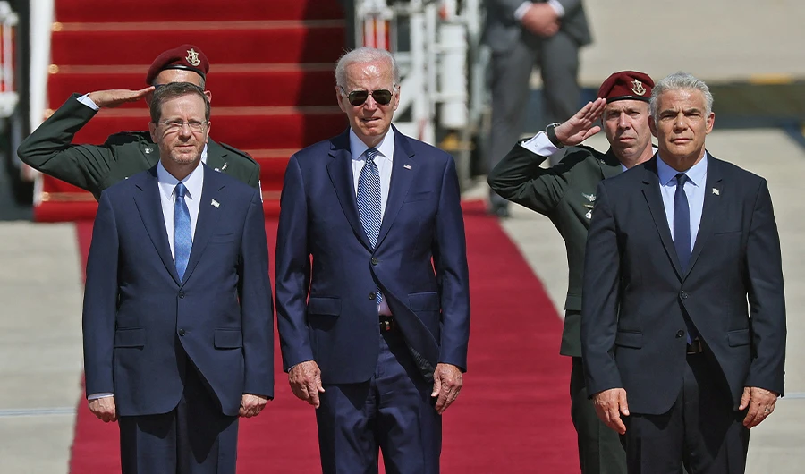 US President Joe Biden (C) is welcomed by Israeli President Isaac Herzog (L) and caretaker Prime Minister Yair Lapid upon his arrival at Ben Gurion Airport in Lod near Tel Aviv, on July 13, 2022. (AFP)