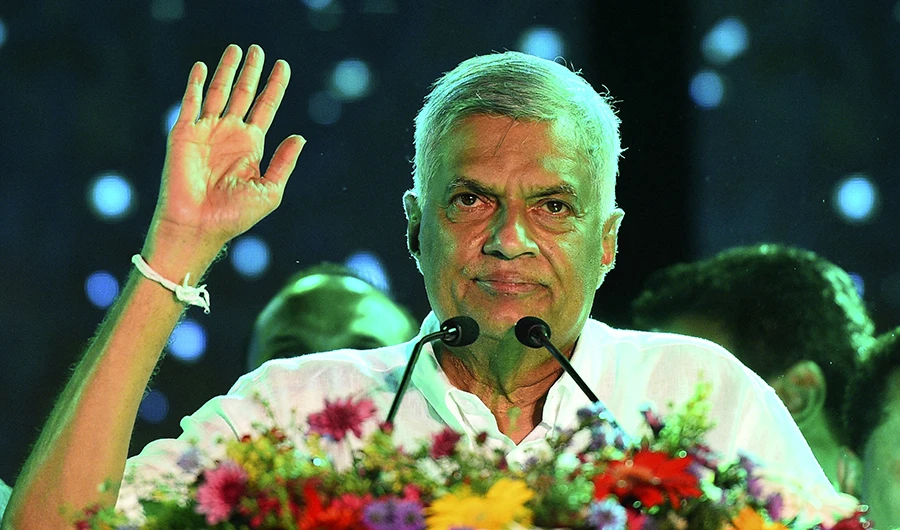 In this file photo taken on August 2, 2020, United National Party (UNP) party leader Ranil Wickremesinghe waves to supporters during the party's final campaign rally ahead of the upcoming parliamentary elections in Colombo. (AFP/FILE)