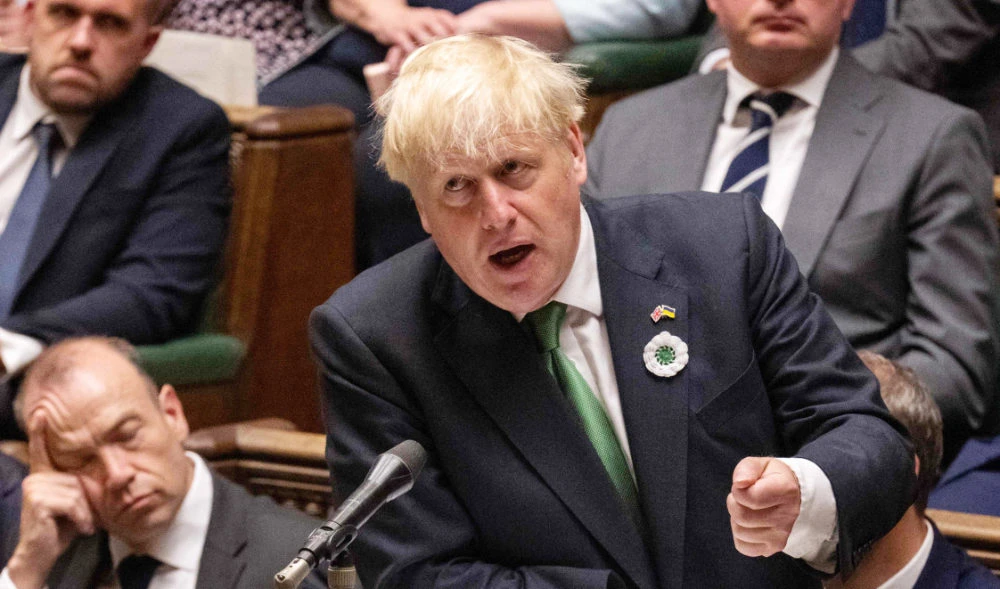 Britain's Prime Minister Boris Johnson gesturing and speaking during the weekly session of Prime Minister's Questions (PMQs) at the House of Commons in London on July 13, 2022. (AFP)