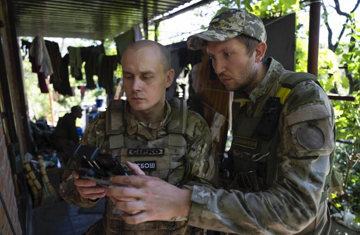 Ukrainian servicemen correct artillery fire by drone at the frontline in Ukraine. (AP)