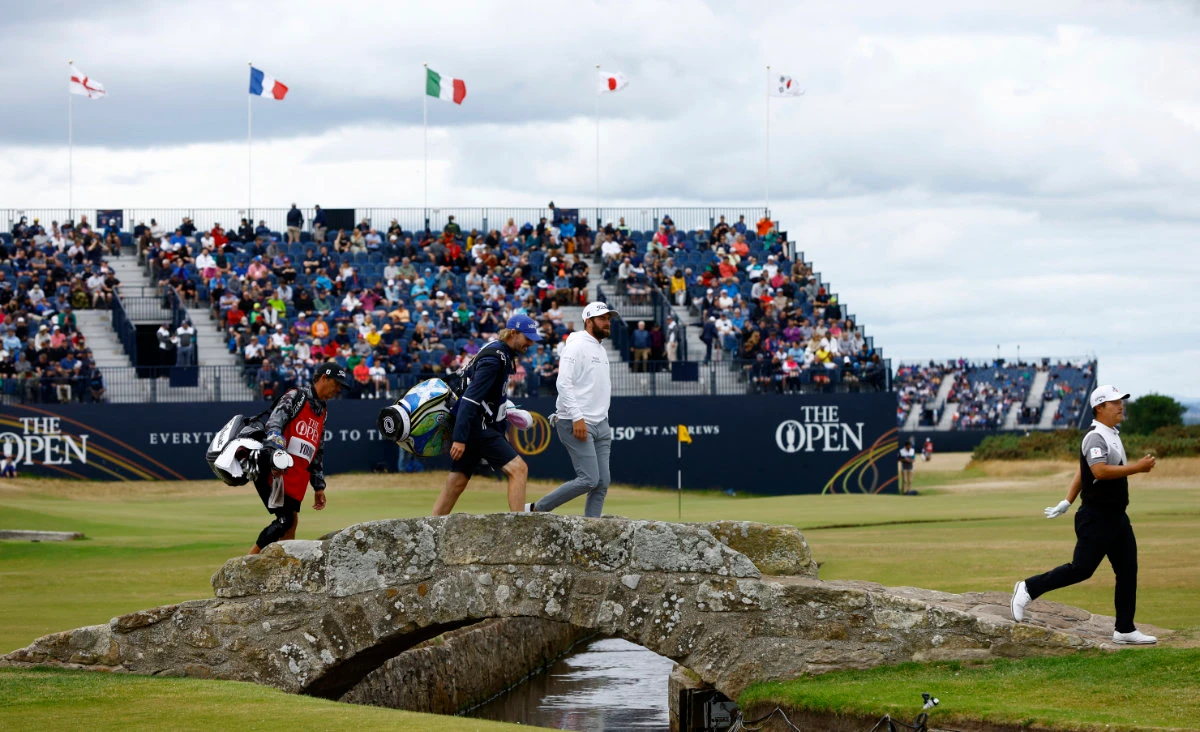Cameron Young of the US and South Korea's K.H. Lee walk over the Swilcan Bridge on the 18th during the first round of the 150th Open Championship at the Old Course, St Andrews, Scotland, on Thursday. (Reuters)