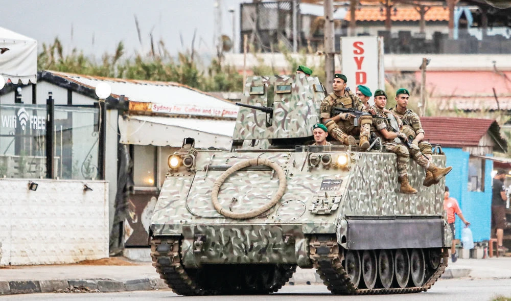A Lebanese army infantry fighting vehicle patrols along a road in Tripoli. The army has announced joint training and exercises with a US team. (File/AFP)